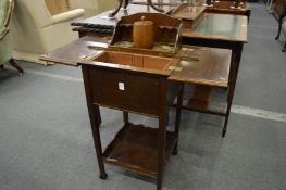 An oak smokers compendium/table with bifold top opening to reveal a rising, fitted interior.