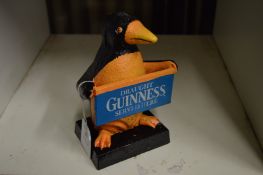 A novelty cast iron Guinness sign.