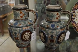 Wittmann, a pair of salt glazed jugs depicting putti.