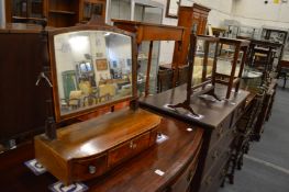 Two toilet mirrors and a small stool or table.