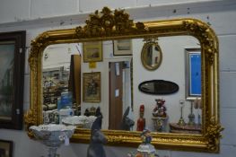 A good large decorative gilt framed over-mantel mirror.