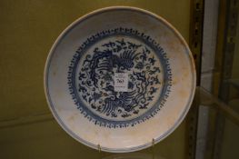 A Chinese blue and white plate decorated with phoenix.