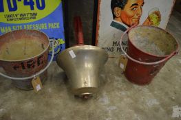 A bronze fireman's bell and two fire buckets.