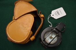 A military compass with leather case.