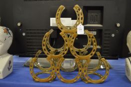 A metal horseshoe wine rack.