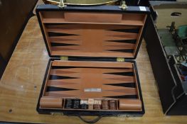 A leather cased back gammon set.