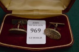 A pair of silver cufflinks.