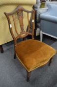 An Edwardian inlaid rosewood occasional chair.