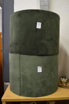 A pair of green velvet lamp shades.