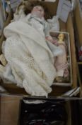 A German porcelain headed doll, a wooden doll and childrens shoes.