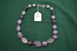 An amethyst bead necklace.