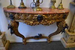 A gilt wood and marble top demi lune console table.