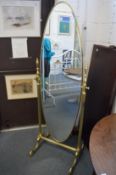 An ornate heavy brass cheval mirror.