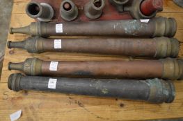 Four early nozzles for fireman's hoses.