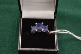 An 18ct white gold and three stone sapphire ring.