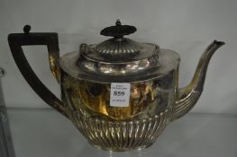 A silver teapot.