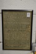 An 18th century alphabet sampler, signed Maria Smith 1767 (some moth damage).