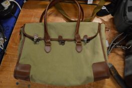 A canvas and leather holdall.