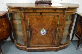 A good Victorian figured walnut credenza, the central panel door inset with a porcelain portrait