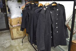 A collection of fireman's uniform to include jackets and trousers.