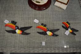 A set of three cast iron Guinness flying toucans.