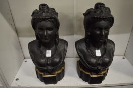 A pair of heavy Victorian cast iron busts of ladies.