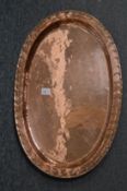 An Arts and Crafts copper oval dish.