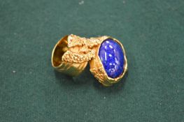A Yves Saint Laurent gilt metal and blue stone neck tie in original box.