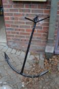 A large wrought iron anchor.
