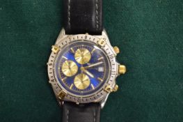 A gentlemans wristwatch with leather strap.