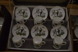 A Royal Worcester box set of six coffee cans and saucers decorated with exotic birds.