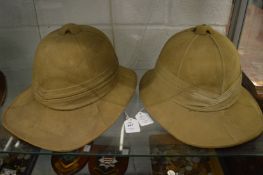 Two pith helmets.