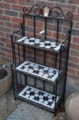A three tier wrought iron plant stand.20