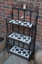 A three tier wrought iron plant stand.20