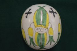 Pottery ball painted with figures.