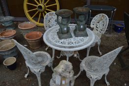 A white painted aluminium patio table and four chairs.