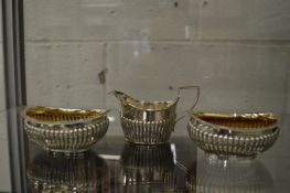 A pair of silver bowls and silver cream jug.