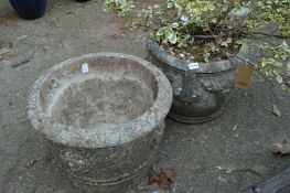 Reconstituted stone planter with shrub together with another planter.