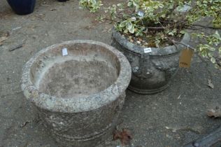 Reconstituted stone planter with shrub together with another planter.