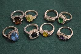 Eight decorative silver rings.