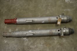 A pair of large nozzles for fireman's hoses.