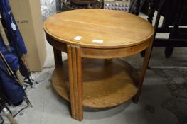 An oak circular two-tier coffee table.