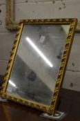 A small gilt framed strut mirror.
