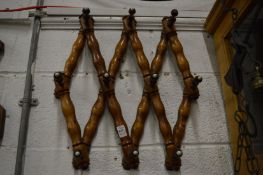 An extendable hardwood coat rack.