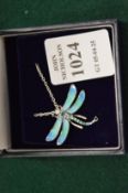 A sterling silver and enamel dragonfly pendant set with a blue topaz complete with chain.