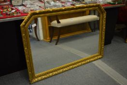 A gilt framed over mantel mirror.
