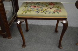A mahogany framed and upholstered stool.