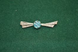 A decorative brooch, possible platinum, diamonds and blue zircon.