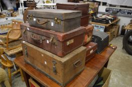 A quantity of luggage, storage boxes and a car trunk.