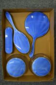 A silver and enamel five piece dressing table set.